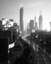 A captivating black and white photograph depicts a futuristic city in glitch mode, bathed in the warm glow of golden hour. Fl