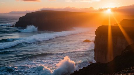 Experience the breathtaking beauty of volumetric lighting illuminating waves crashing against dramatic cliffs during a vibran