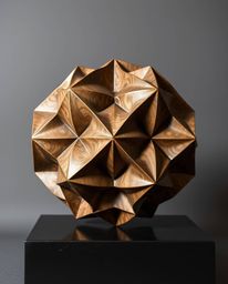 A captivating cast bronze sculpture features a 3D geometric pattern reminiscent of folded paper.  The interplay of light and 