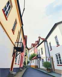Discover a captivating watercolor painting depicting a sleepy town with pastel-colored houses.  The low angle perspective and