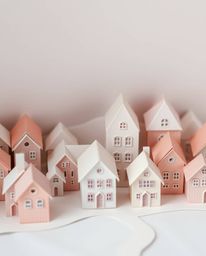 Discover a charming sleepy town depicted in an intricate origami style.  Pastel-colored houses are meticulously folded with g