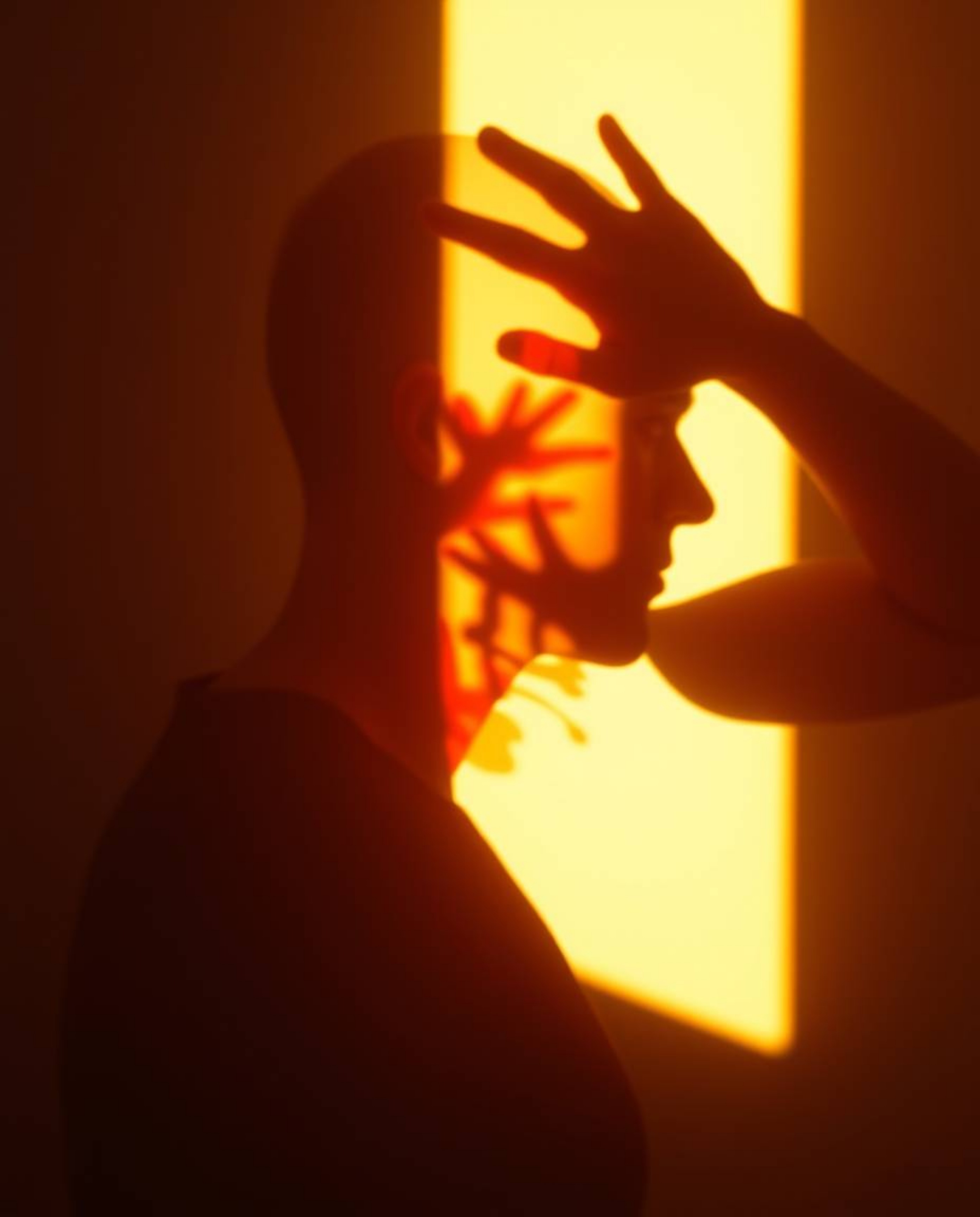 Explore captivating modern art featuring a warm and gentle light illuminating a human silhouette formed by colorful splash pa
