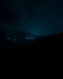 Explore intense black and dark soft professional photography showcasing a glowing bioluminescent digital glitch landscape. Th