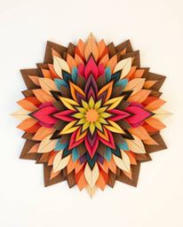 Explore a stunning layered papier-mâché geometric floral mandala featuring vibrant colors and a symmetrical design. This scul