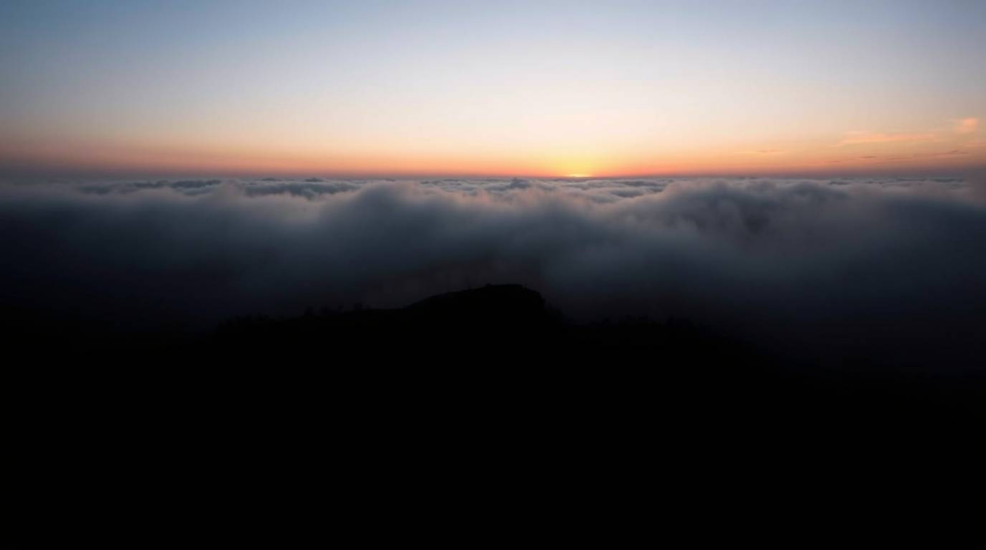 Experience the breathtaking beauty of a foggy sunset landscape. This image showcases dramatic chiaroscuro lighting, with stro