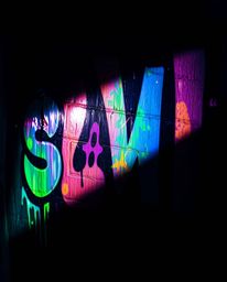 Explore the dramatic interplay of high contrast and low-key lighting in this striking street art aesthetic. Iridescent colors