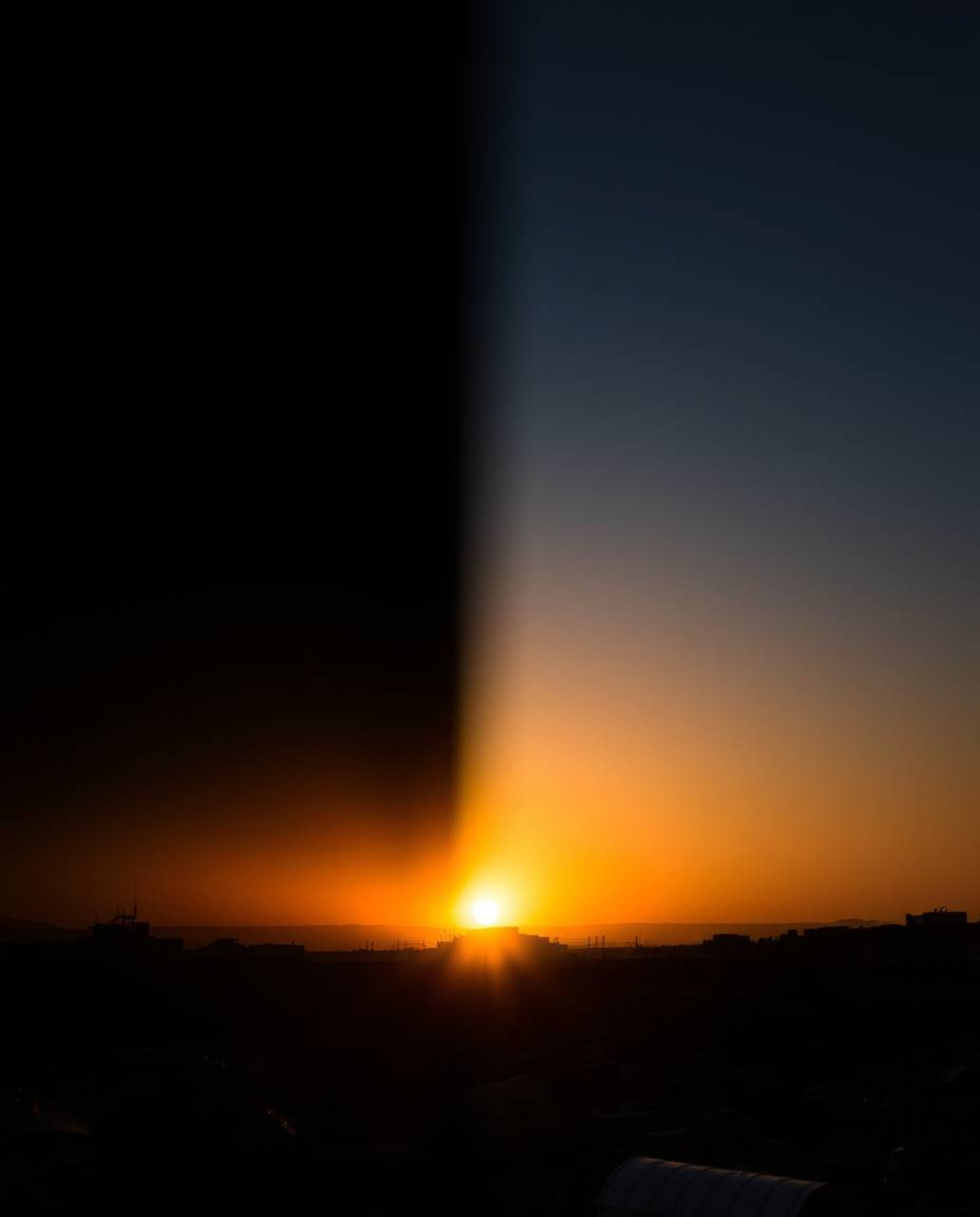 Experience the stark beauty of a sunrise over a war-torn landscape, rendered in dramatic chiaroscuro lighting and a distinct