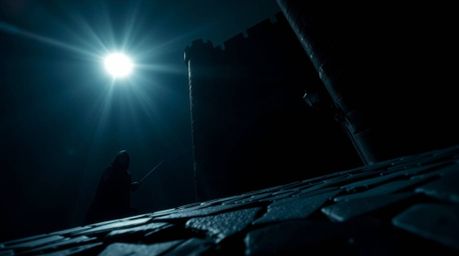A thief utilizes stealth and cunning to infiltrate a heavily guarded castle, captured in a low-angle perspective with intense