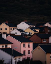 Explore a collection of fine art photographs and watercolor-style images featuring a sleepy town adorned with pastel houses. 