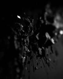 This image showcases an extreme macro close-up of a digital glitch landscape dramatically breaking apart against a pure black
