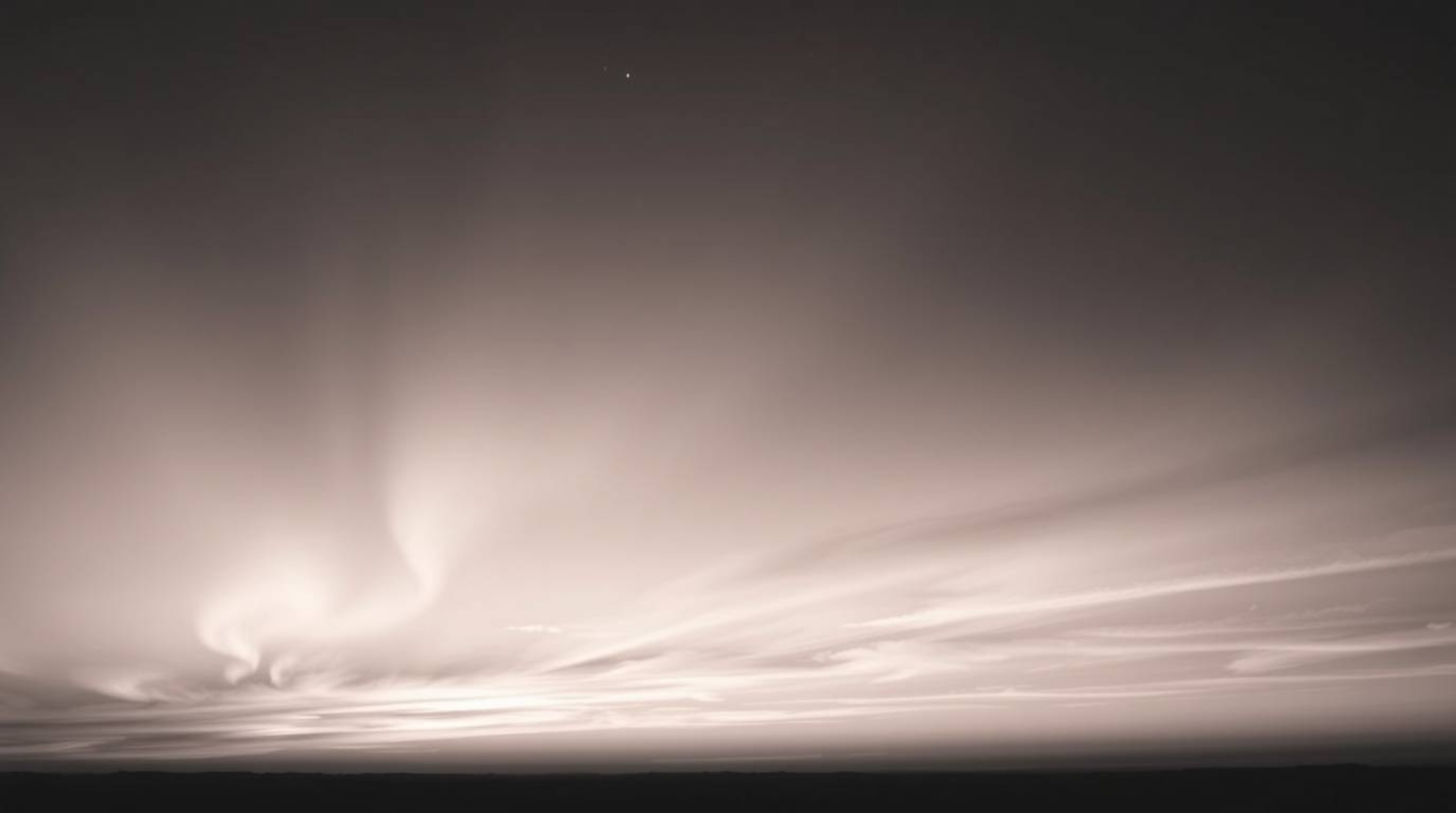Capture the timeless elegance of a sunset sky illuminated by the mesmerizing dance of the Northern Lights in this classic bla