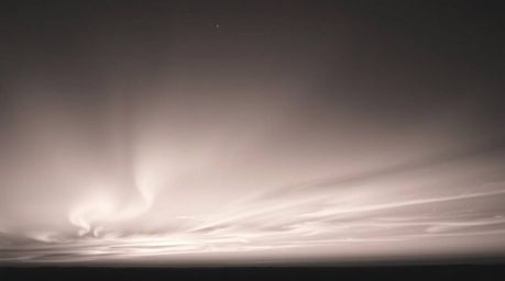 Capture the timeless elegance of a sunset sky illuminated by the mesmerizing dance of the Northern Lights in this classic bla