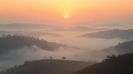 Experience the ethereal beauty of a dreamlike sunset landscape. This stunning 8k resolution image features fog-covered hills 