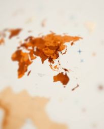 This stunning image features a blurred bokeh effect showcasing a world map formed from bright, colorful splashes. Utilizing a