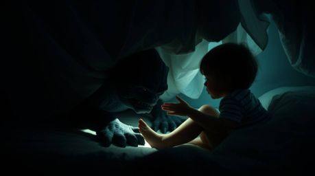 A heartwarming scene unfolds as a gentle, soft light illuminates a monster lurking under the bed, who unexpectedly becomes be