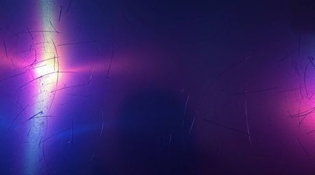 An eerie and unsettling atmosphere emanates from this image, highlighting an iridescent gradient texture applied to a metalli