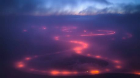 A breathtaking photograph captures a dreamy river delta bathed in the soft glow of twilight.  Hazy light creates a magical at