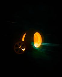 This captivating long-exposure photograph depicts a magical pumpkin undergoing a fantastical transformation into a carriage. 