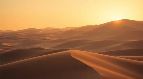Experience the magic of a desert sunset with this captivating image featuring golden dunes bathed in strong, hard light, yet 