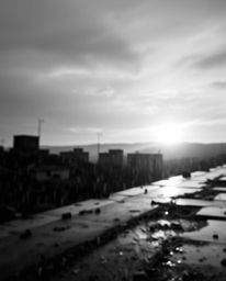 A captivating black and white photograph depicting a sunrise over a war-torn landscape, rendered with a beautiful blurred bok