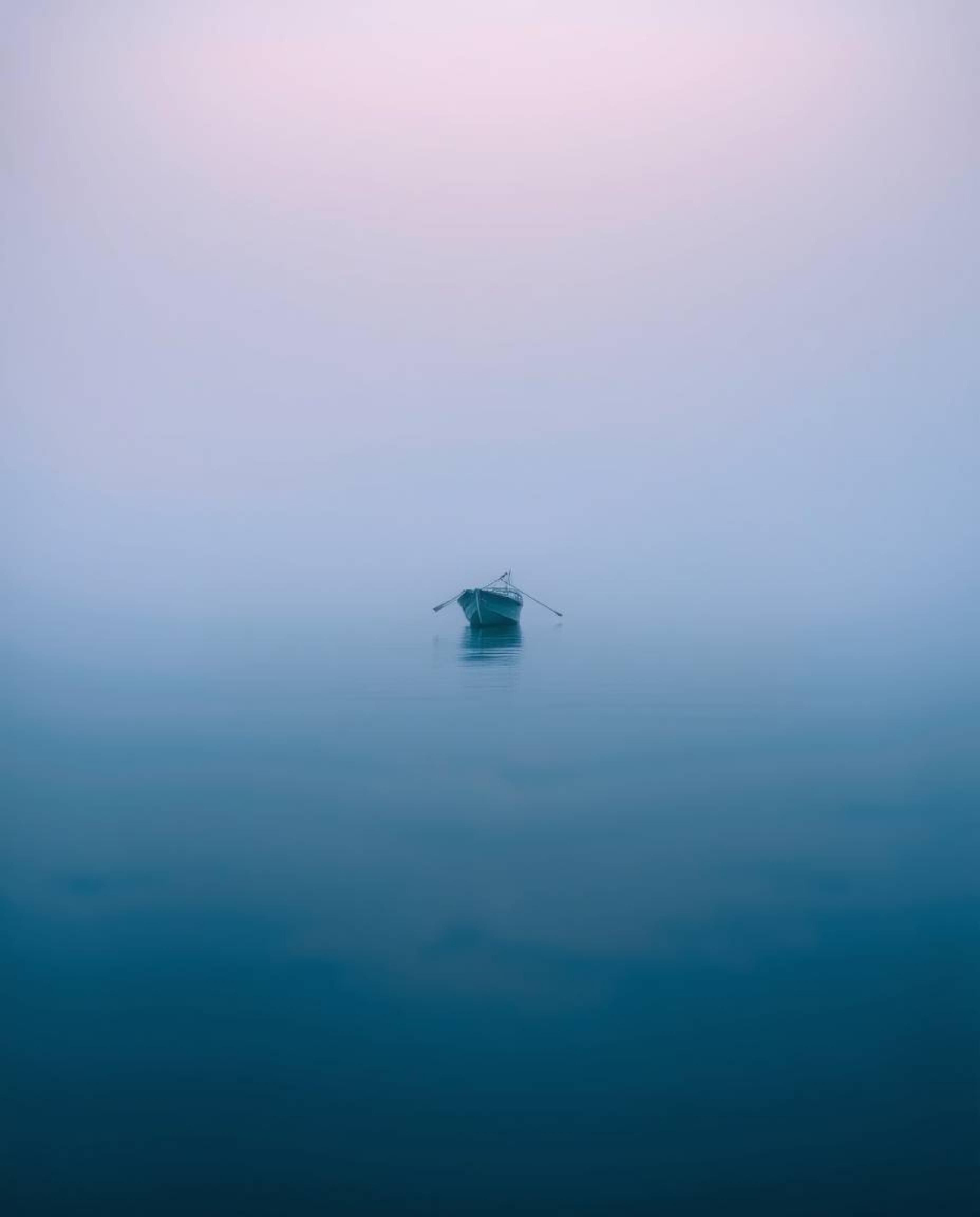 A boat drifts on a lake at sunset, the scene rendered with a cool color palette and blurred bokeh effect, enhancing the low v