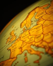 A tight close-up shot with detailed focus showcases a mesmerizing glowing map projection within the ambiance of an old study.