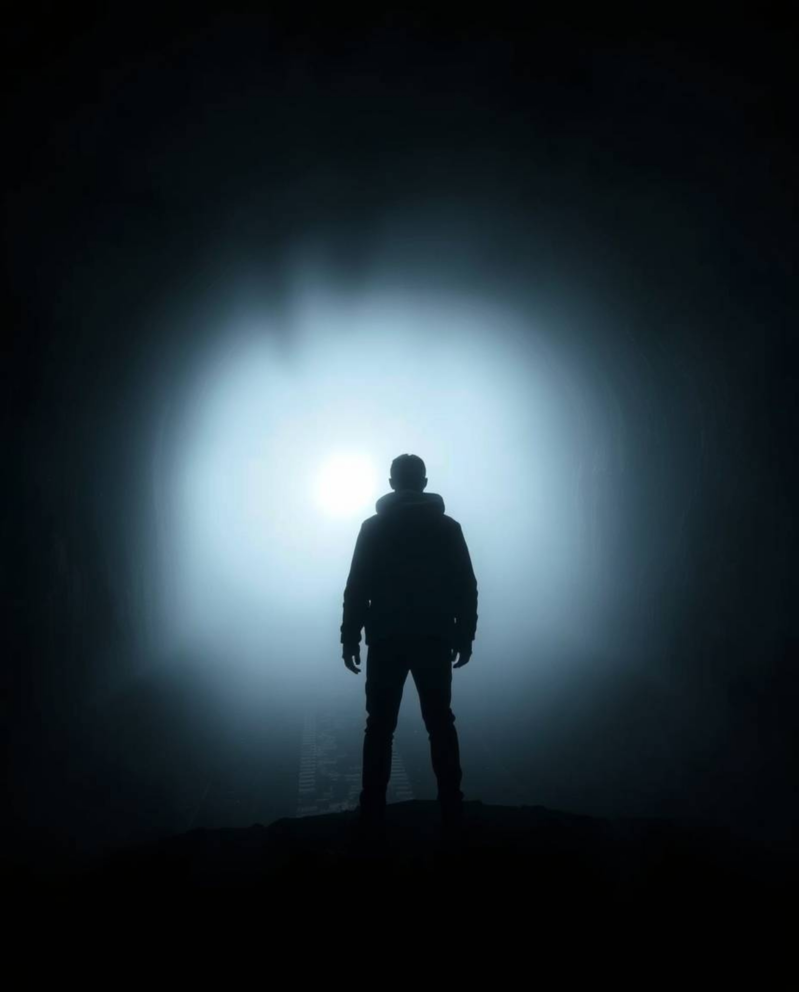 A captivating image depicting a mysterious figure standing at the edge of a tunnel, gazing towards a distant light obscured b