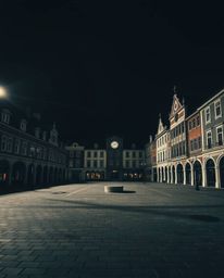 This high-resolution stock photo showcases an empty town square, characterized by the haunting sound of ticking clocks. The s