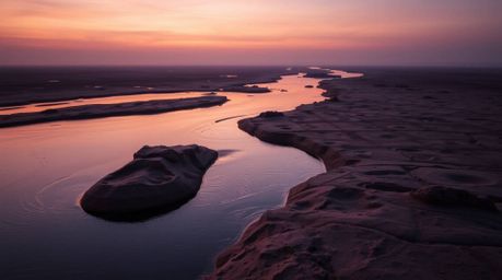 A mesmerizing river delta scene bathed in the soft, glowing colors of twilight, meticulously sculpted in clay. The gentle lig