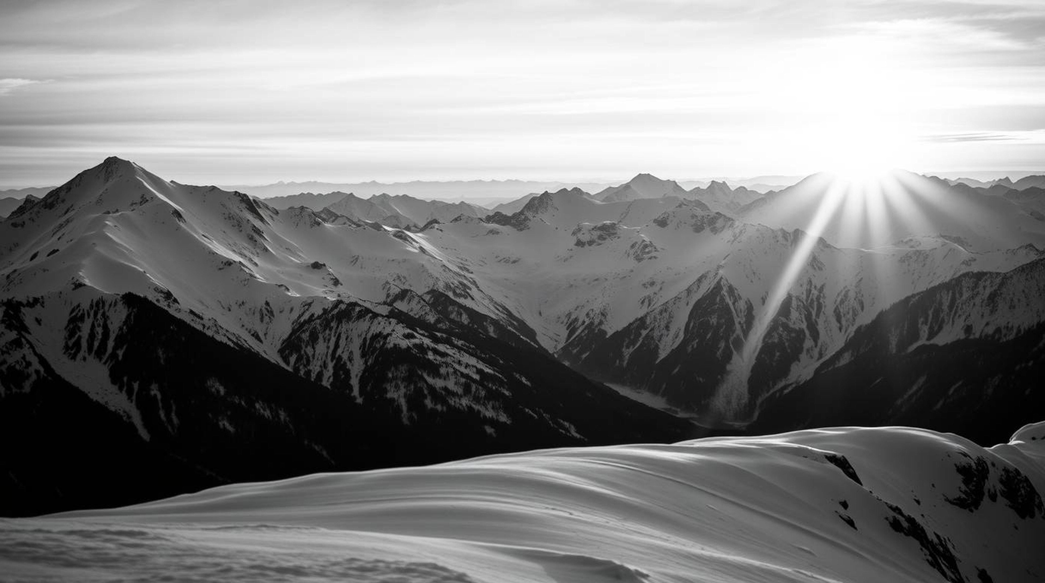 A stunning close-up captures the timeless elegance of snow-capped mountains bathed in the warm glow of a sunset.  The black a