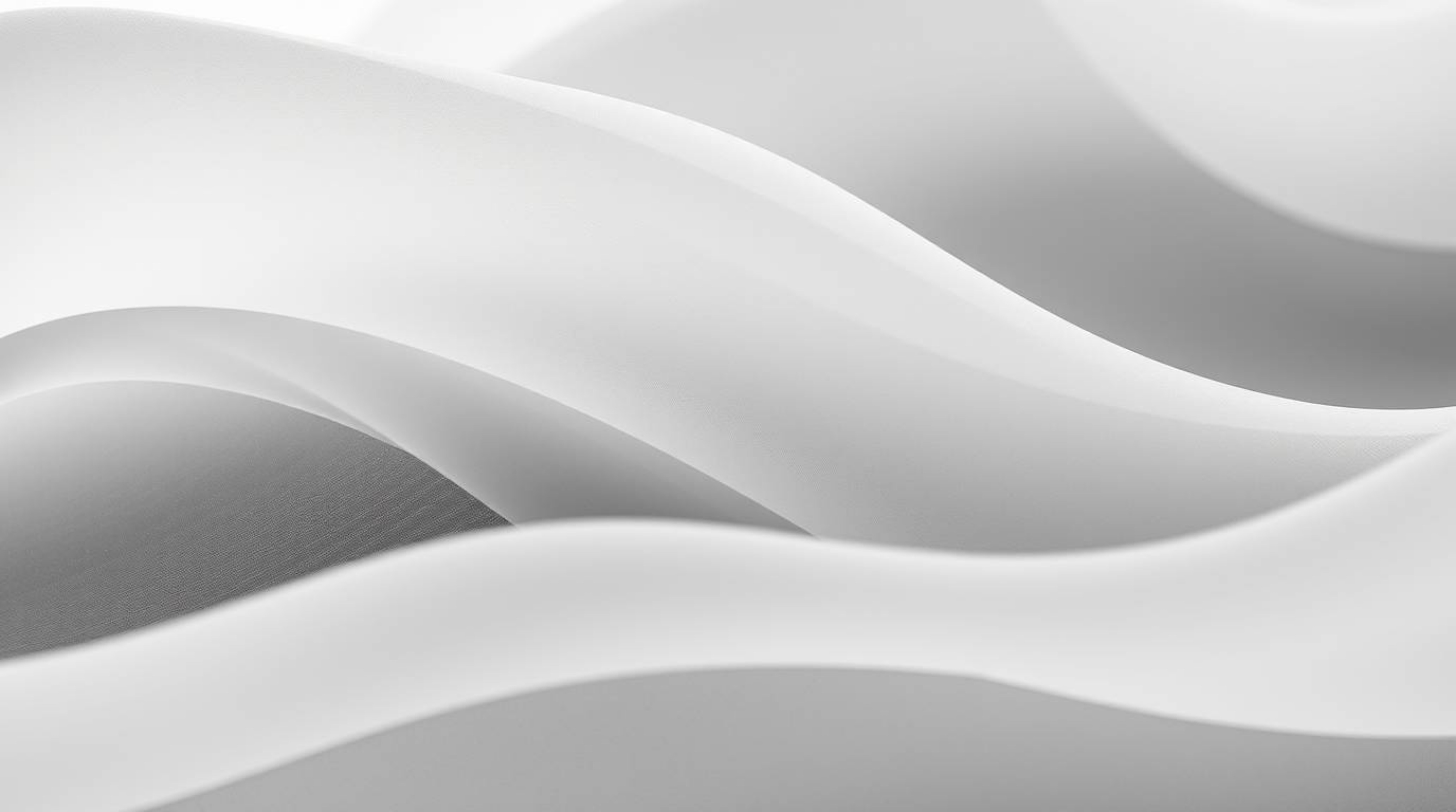 This stunning black and white photograph showcases a tight close-up of a fluid abstract wave with a beautiful pastel gradient