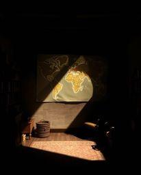 Explore a captivating scene featuring contrasting chiaroscuro lighting and natural earth tones, where a glowing map is projec