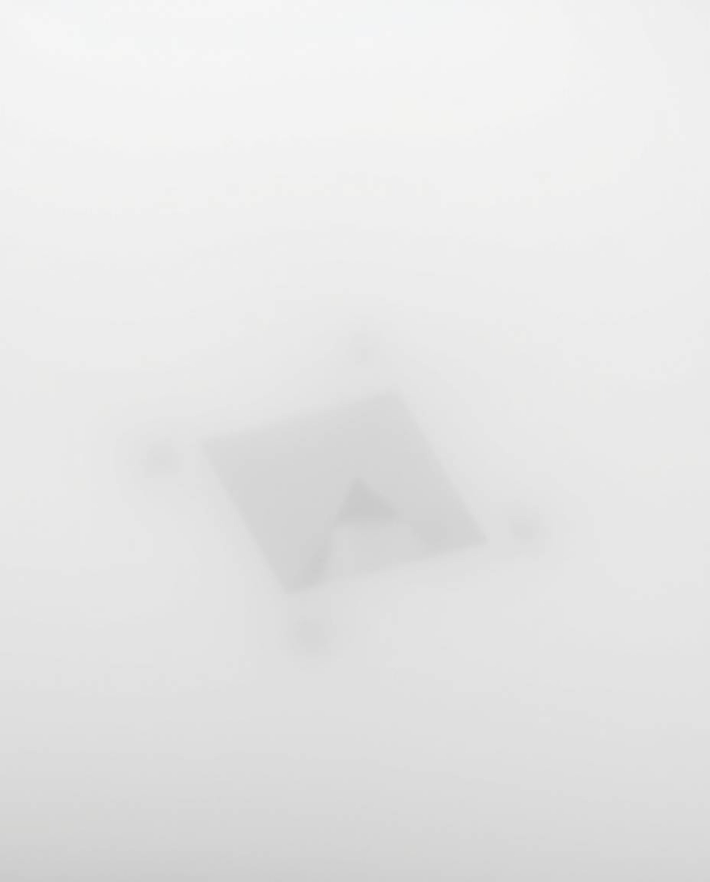 This striking black and white image features a thick fog dramatically obscuring a geometric optical illusion pattern in a cap