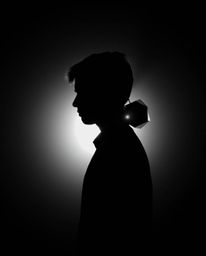 A captivating black and white image showcasing a silhouetted subject bathed in backlighting, seamlessly integrated with a geo
