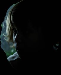 Capture the wonder of childhood with a high contrast, close-up shot showcasing a child's awestruck face as they stumble upon