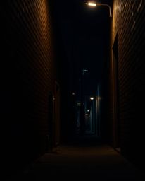 This high-resolution stock photo captures the unsettling feeling of being watched. A pair of eyes peers out from the dark sha