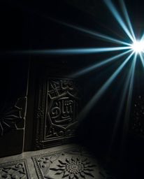 This dark and eerie photograph captures the unsettling beauty of Islamic geometric patterns carved in stone. Bright lens flar