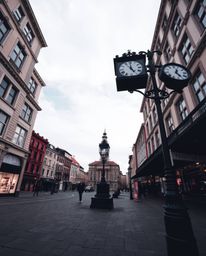 A captivating low-angle street photograph captures an empty town square, presenting a candid urban scene with a dramatic pers
