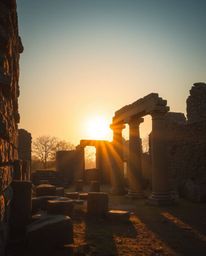 An image depicting a sunset casting shadows through ancient stone ruins, conveying an ethereal and spiritual vibe. The scene 