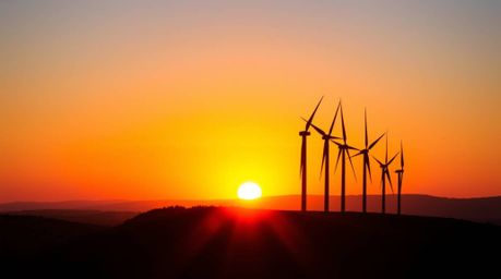 Capture the essence of sustainable energy with this high-resolution commercial stock photo.  A breathtaking sunset paints the