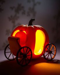 A bright and vibrant pumpkin undergoes a magical transformation into a carriage, bathed in gentle soft light that creates dif