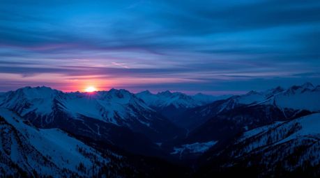 Capture the serene beauty of snow-covered mountains bathed in the ethereal glow of a pastel sunset. This cool-toned image fea
