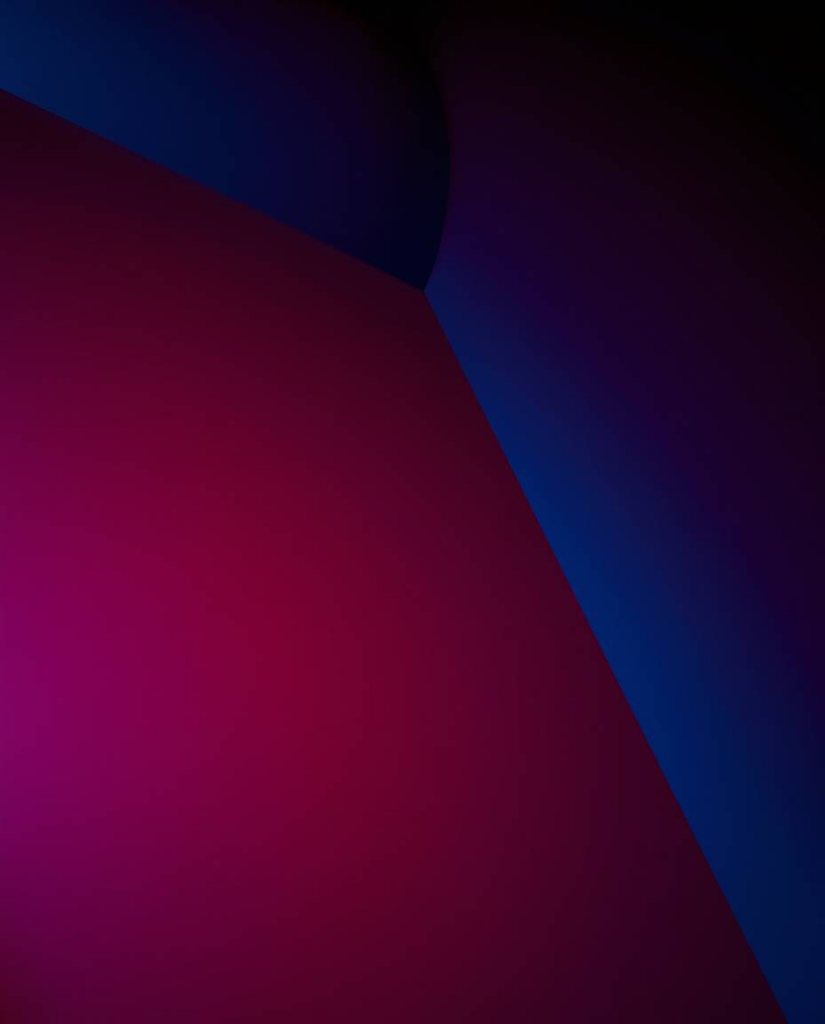 This image features a sophisticated, low-angle perspective of a rich burgundy and deep blue backdrop adorned with a black and