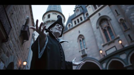 A captivating candid street photograph depicts a classic Disney villain casting a spell in an old castle.  The low-angle pers