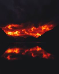 This image presents a dramatic composition featuring fiery cloud reflections in a mountain lake, captured in a cinematic styl