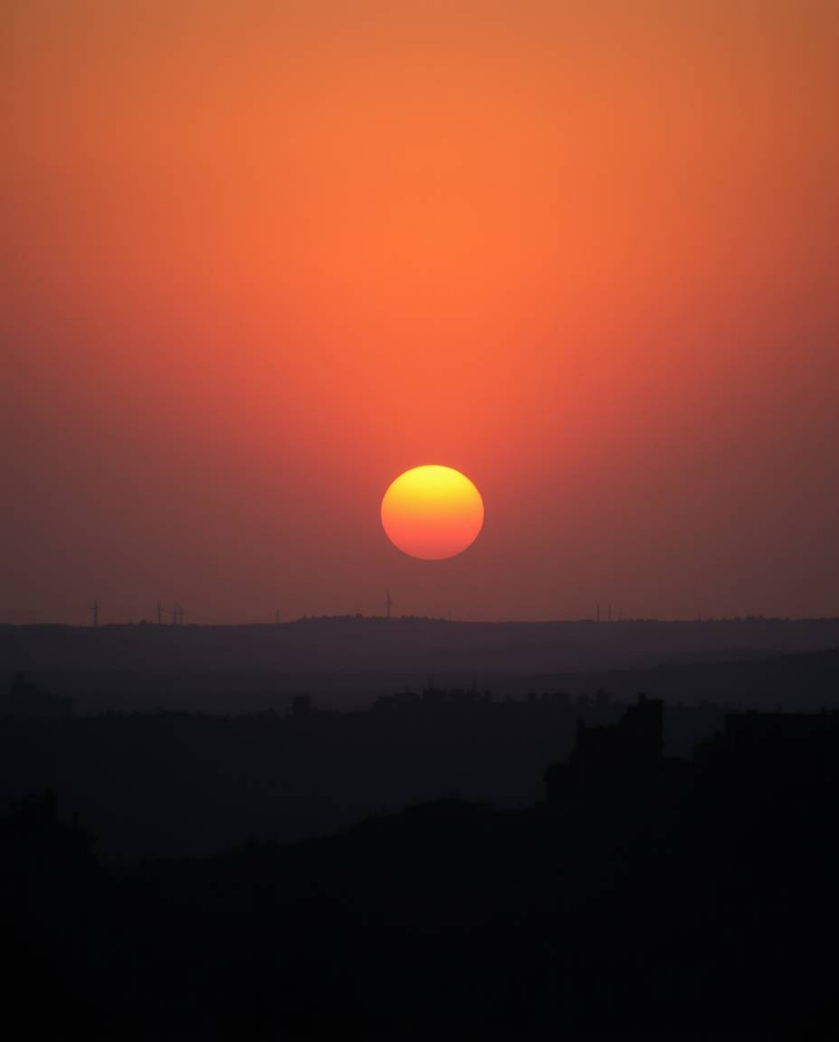 A breathtaking fine art photograph captures a sunrise over a war-torn landscape.  The image, reminiscent of Associated Press 