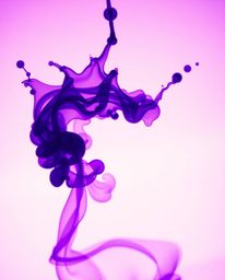A captivating long-exposure macro photograph showcases vibrant purple and ultraviolet hues of ink splashing in water.  The hi