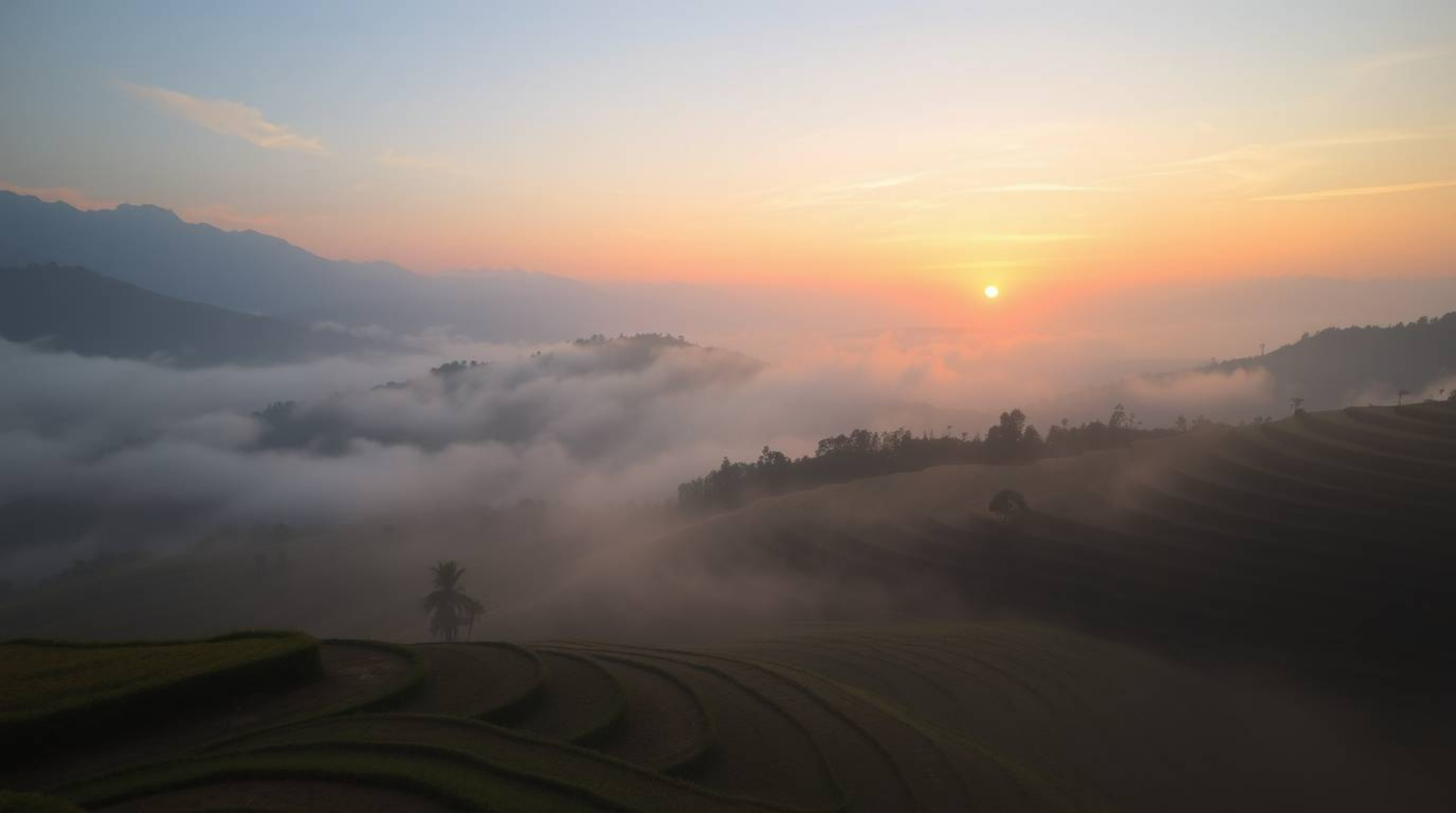 Capture the essence of a breathtaking sunset painting the rice terraces in the mountains with an ethereal glow. Gentle color 
