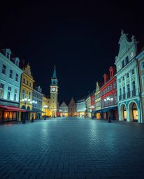 A professional photograph capturing an empty town square bathed in vivid electric colors, subtly contrasted and softly satura
