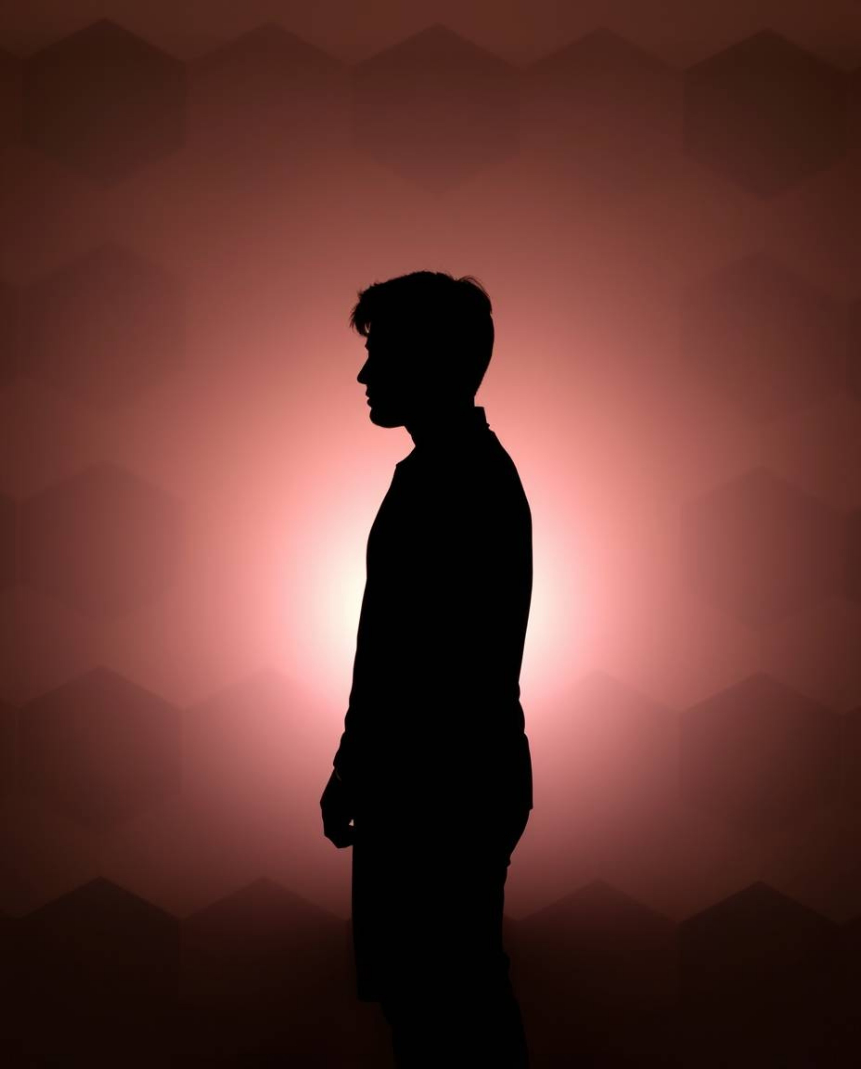 A captivating image featuring a silhouetted figure backlit against a stunning geometric pastel gradient wallpaper. This soft,